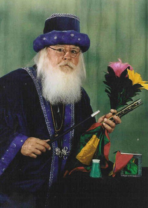 A man with a beard is holding a magic wand