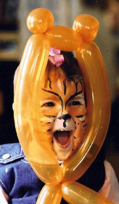 A little girl with her face painted like a tiger