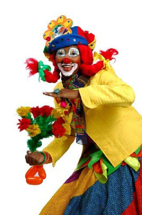 A clown is holding a bunch of balloons in his hand