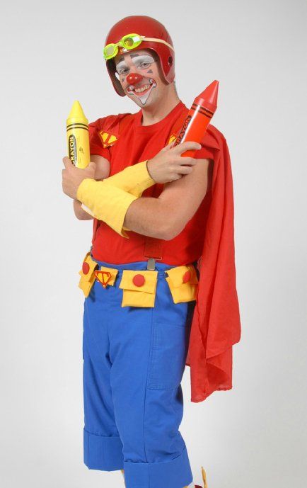 A man dressed as a clown is holding a crayola crayon