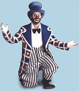 A clown in a striped suit and top hat is kneeling down.