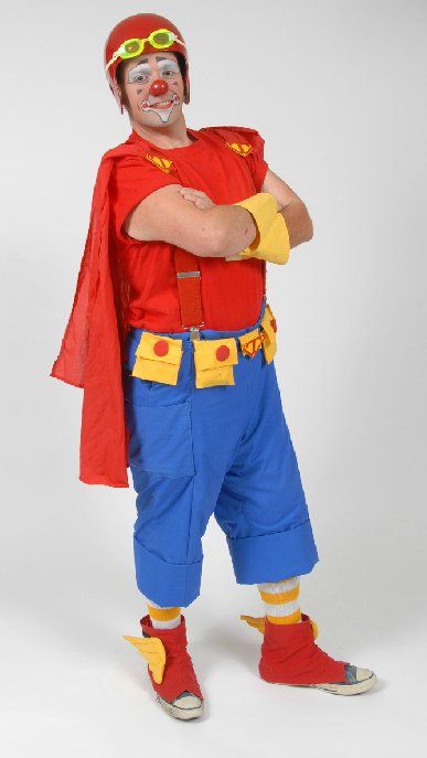 A man dressed as a clown with his arms crossed