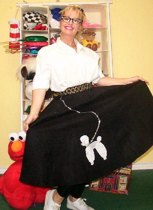 A woman wearing a black skirt with a white poodle on it