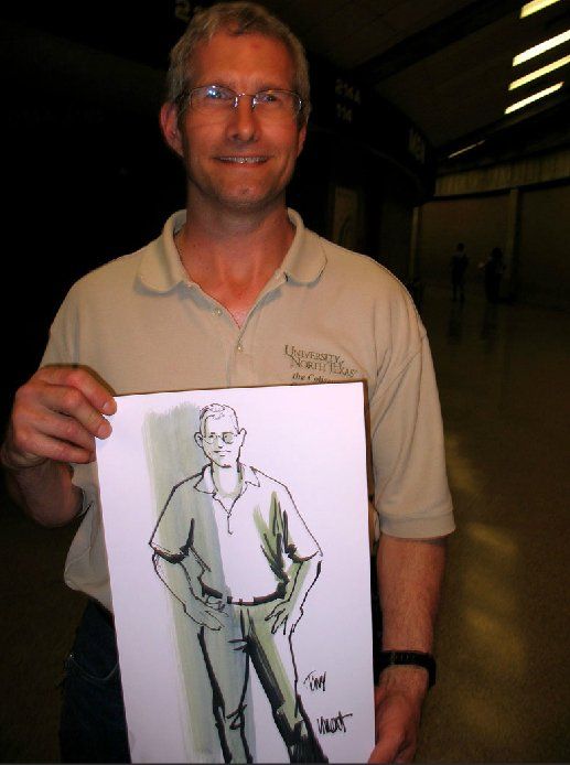 A man holding up a drawing of a man with the word bart on it
