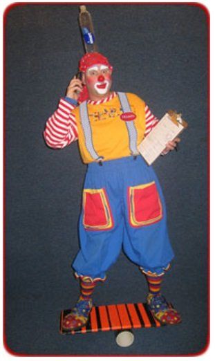 A clown talking on a cell phone while holding a piece of paper