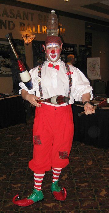 A man dressed as a clown holding a juggling stick