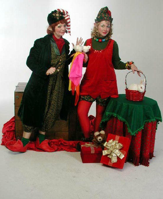 Two women dressed as elves are standing next to each other