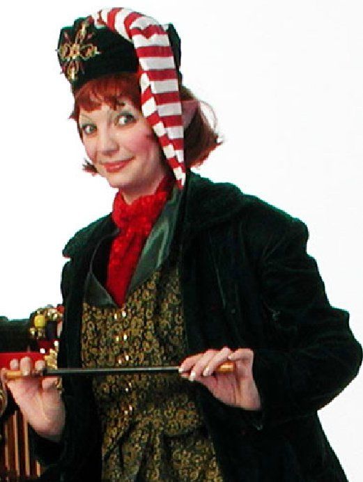 A woman dressed as an elf is holding a wand