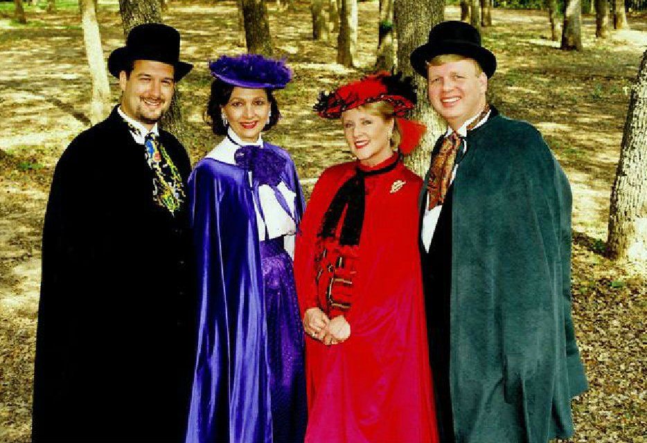 A group of people dressed in costumes are posing for a picture