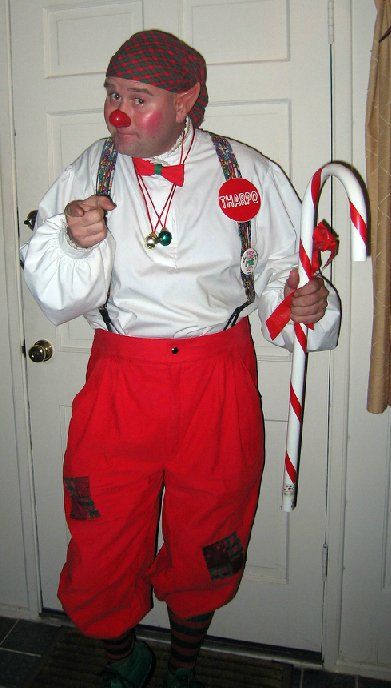 A man dressed as a clown is holding a candy cane