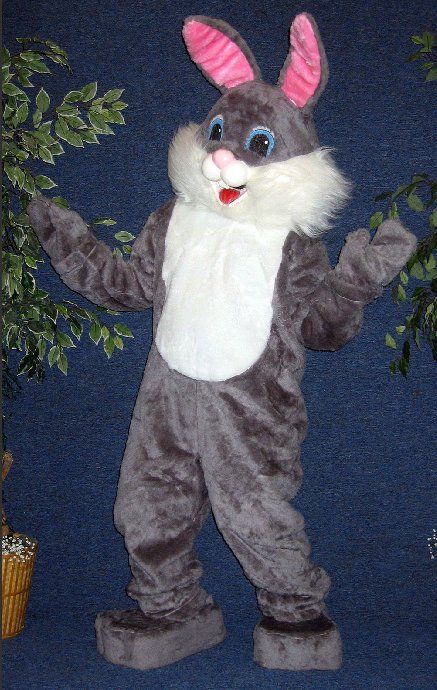 A mascot in a bunny costume is standing in front of a plant.