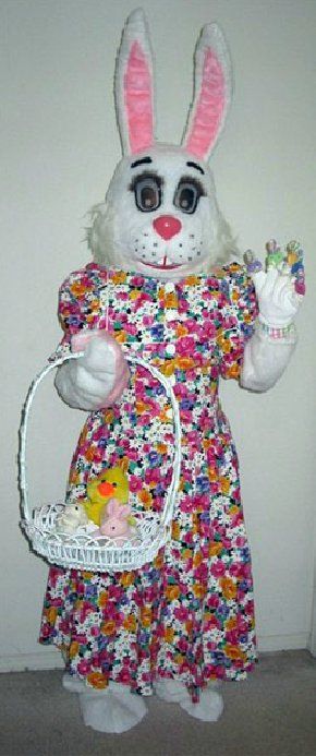 A mascot dressed as an easter bunny is holding a basket of eggs.