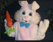 A stuffed easter bunny is holding a carrot in his hand.