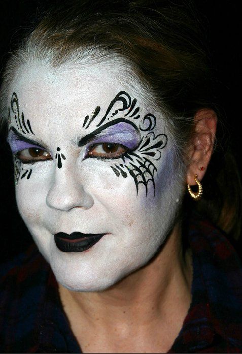 A woman with a spider web painted on her face