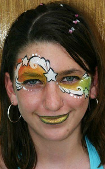 A young girl with a face painted design on her face