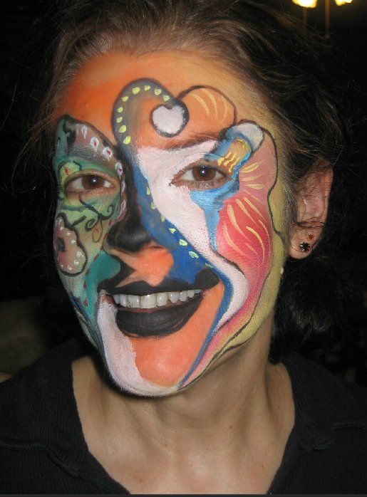 A woman with a colorful face painted on her face