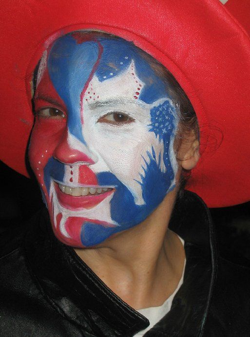 A person with their face painted in red white and blue