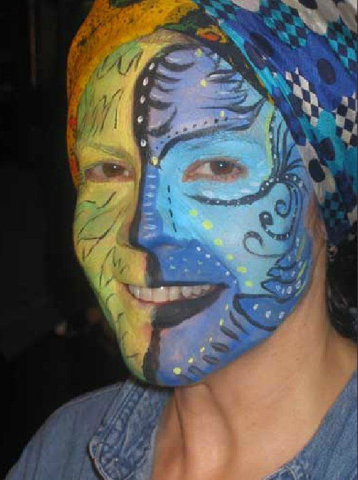 A woman with her face painted in different colors
