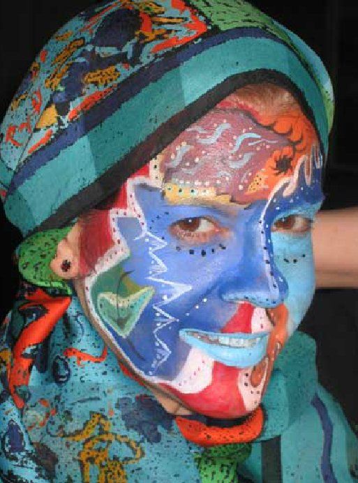 A person with their face painted has a scarf around their neck