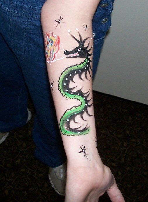 A person has a dragon painted on their arm