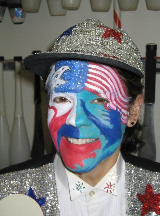A man with his face painted in the colors of the american flag
