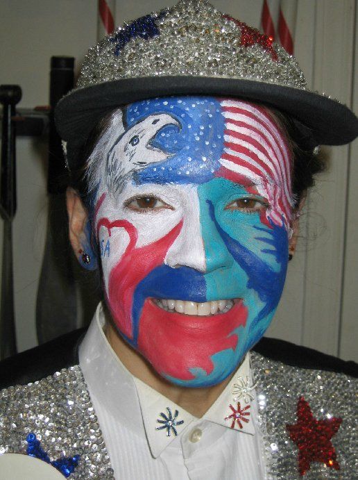 A man with his face painted in the colors of the american flag