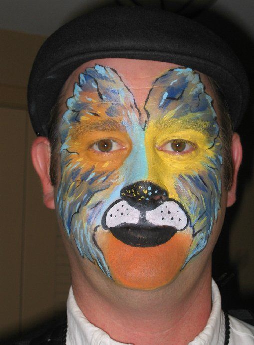 A man with his face painted like a wolf
