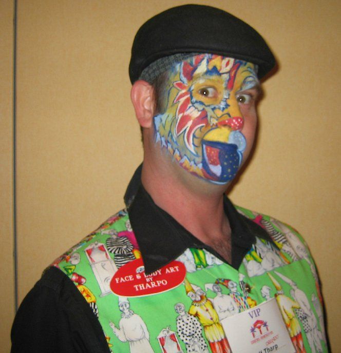 A man with his face painted has a name tag that says vip