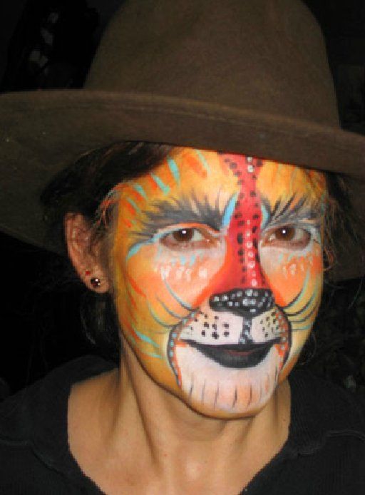 A woman with her face painted like a tiger