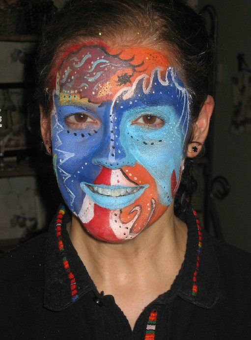 A woman with her face painted in various colors