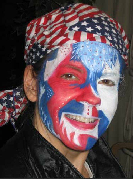A woman with her face painted in the colors of the american flag