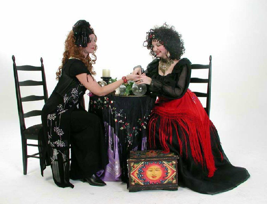 Two women are sitting at a table talking to each other