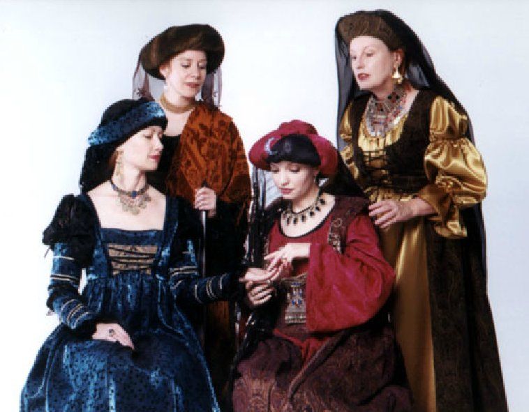 A group of women dressed in medieval costumes are posing for a picture