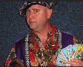 A man in a hat is holding a fan of cards.