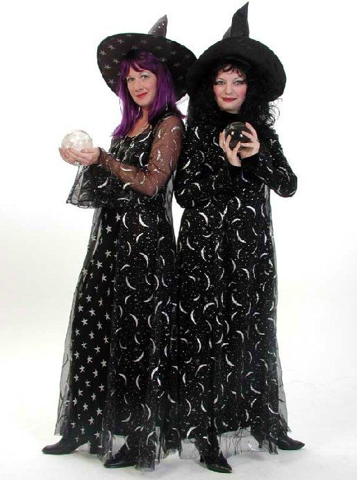 Two women dressed as witches are standing next to each other