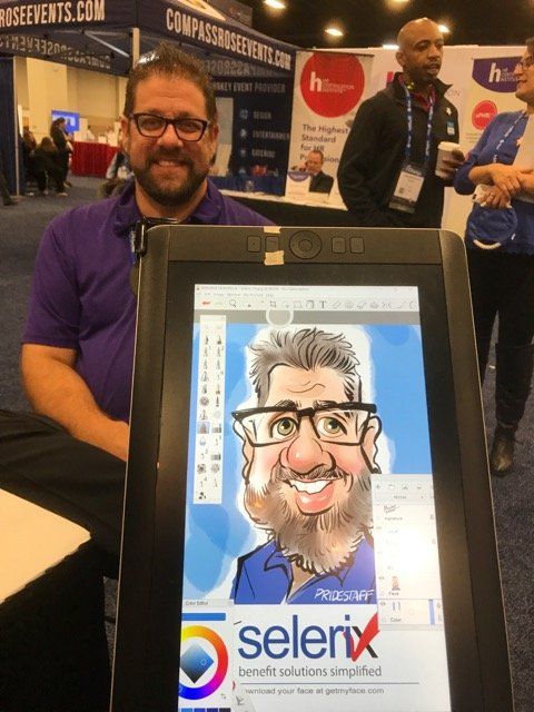 A man is holding a tablet with a caricature of him on it