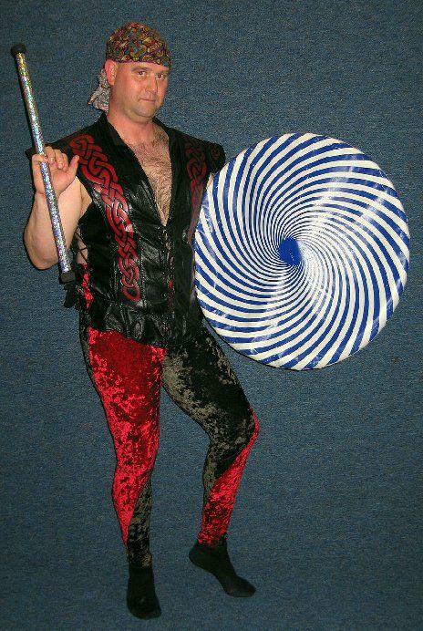 A man in a pirate costume is holding a blue and white striped object