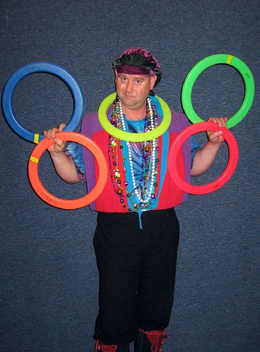 A man is holding a bunch of colorful rings in his hands