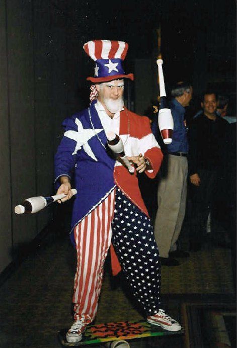 A man dressed as uncle sam is juggling clubs