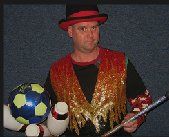 A man in a top hat is holding a wand and a soccer ball.