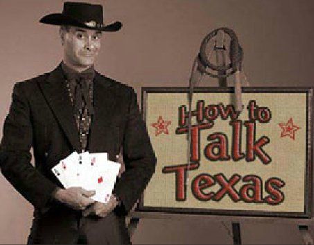 A man in a cowboy hat is holding playing cards in front of a sign that says how to talk texas