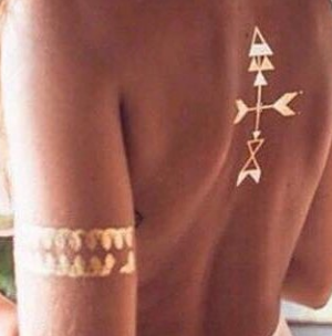 A woman has a tattoo on her back that looks like an arrow.