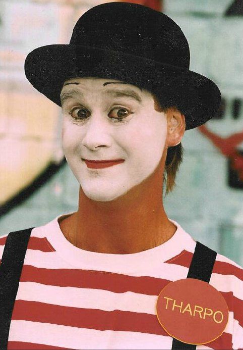 A man with white face paint and a name tag that says tharpo