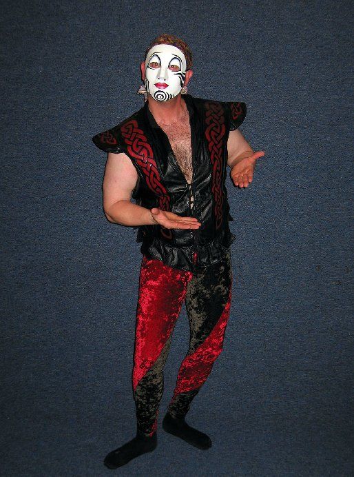 A man wearing a mask and a black and red outfit