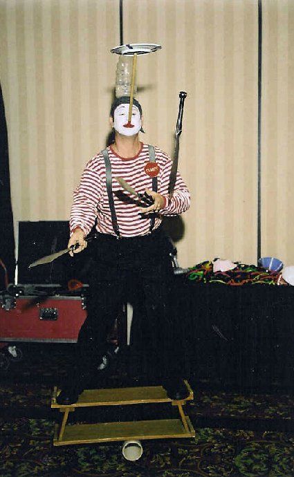 A mime is balancing a plate on his head