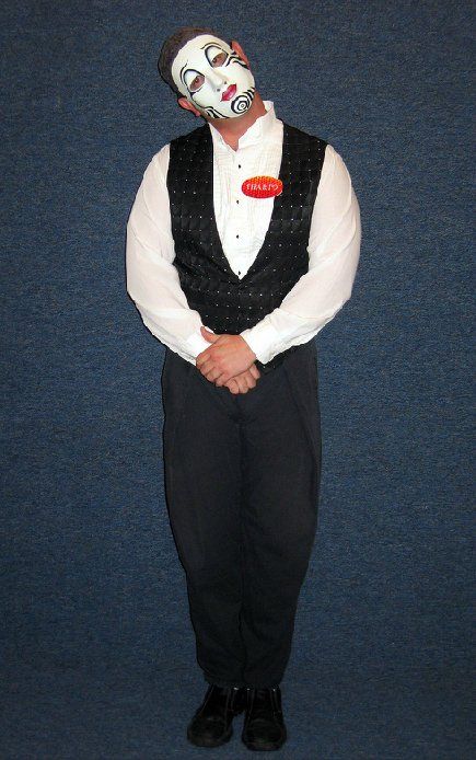 A man in a tuxedo with a mask on his face