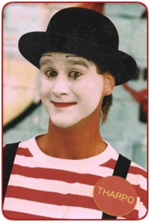 A mime wearing a red and white striped shirt with a tag that says tharpo