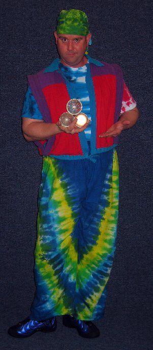 A man in a tie dye outfit is holding a light
