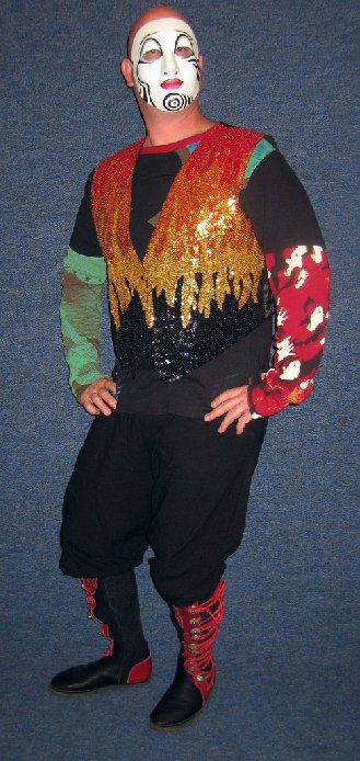 A man in a clown costume is standing with his hands on his hips