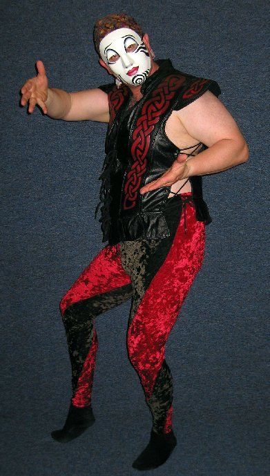 A man wearing a mask and red and black pants